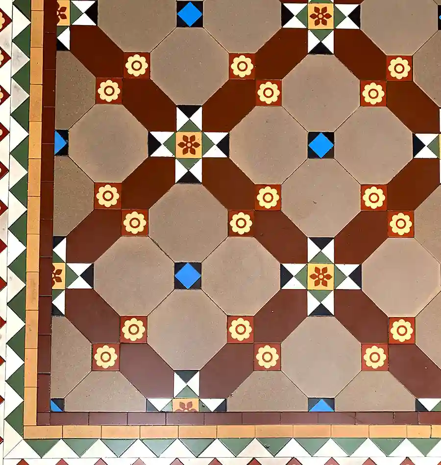 Original Victorian geometric and encaustic tile floor showing octagonal and dot pattern with decorative borders, professionally restored as part of a mosaic conservation project in Edinburgh, Scotland.
