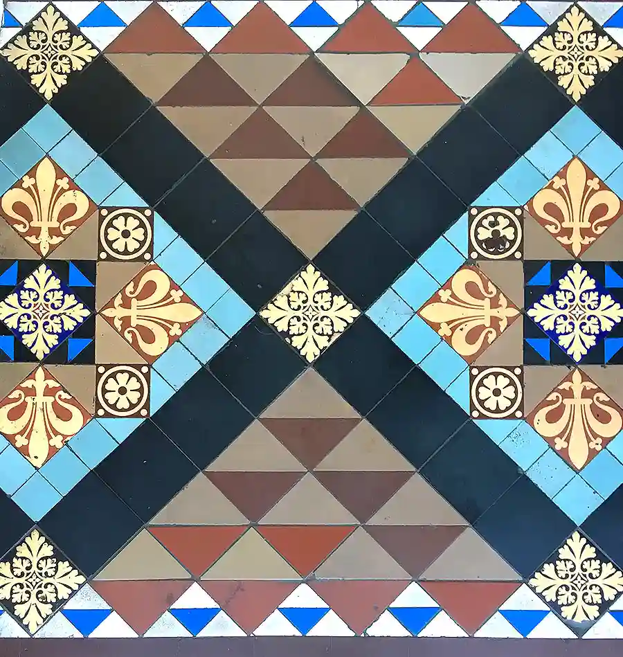 Detail of a Victorian geometric tiled floor restored in Portobello, Edinburgh, showing traditional encaustic tiles, decorative borders and colour-matched conservation repairs.