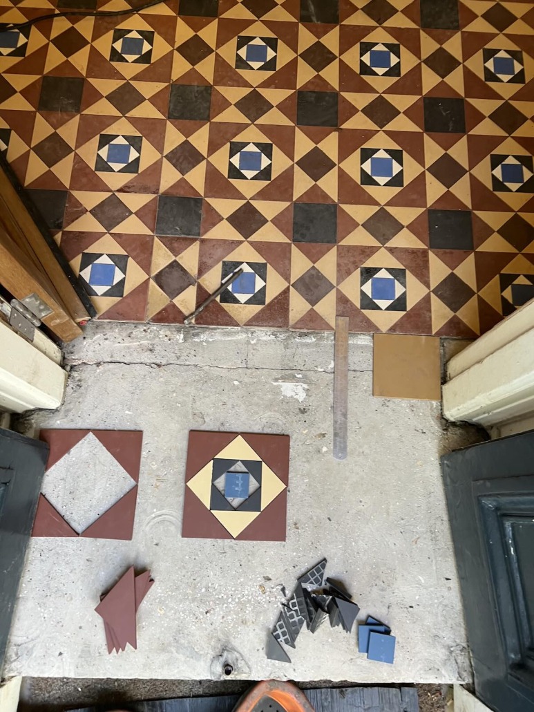 Extension and repair of an original Victorian geometric tile floor in a New Town property, Edinburgh, using carefully matched replacement tiles.