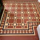 New Victorian geometric tile floor installation in a period property in Pollokshields, Glasgow, featuring traditional red, cream and black tiles with decorative borders.